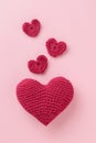 Crocheted amigurumi pink heart with crochet hook and skein of yarn on a pink background. Valentine\'s day banner