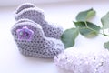 Crocheted baby shoes with a star and sequins Royalty Free Stock Photo