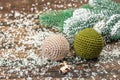 Crocheted Christmas balls and holiday decor. Snow-covered fir tree branches Royalty Free Stock Photo