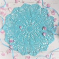 A crocheted doily on white background.