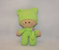 The crocheted doll in light green clothes