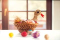 Crocheted Easter eggs and straw hen in wicker basket Royalty Free Stock Photo