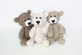 Crocheted gray and brown bears on a white background. Crocheted toy.