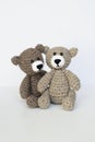 Crocheted gray and brown bears on a white background. Crocheted toy.