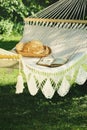 Crocheted hammock with hat and book