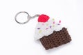 Crocheted keychain in the shape of a vanilla and raspberry cupcake