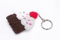 Crocheted keychain in the shape of a vanilla and raspberry cupcake