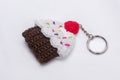Crocheted keychain in the shape of a vanilla and raspberry cupcake
