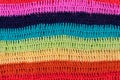 Crocheted multi colored striped fabric texture for background