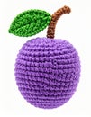 Crocheted Purple Plum with Green Leaf and Brown Stem on White Backdrop Royalty Free Stock Photo