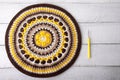 Crocheted yellow-brown round mandala