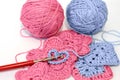 Crocheting project with pink and blue yarn