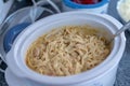 Crock pot of chicken and noodles for Thanksgiving dinner