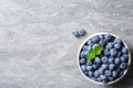 Crockery with fresh blueberries and space for text on table Royalty Free Stock Photo