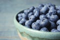 Crockery with juicy and fresh blueberries on wooden table Royalty Free Stock Photo