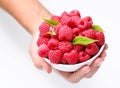 Crockery with raspberries in woman hands. Royalty Free Stock Photo