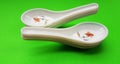 crockery spoon isolated on green background