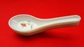 crockery spoon isolated on red background