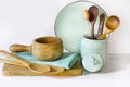 Crockery, vintage tableware, utensils and other different white and turquoise stuff on white table-top. Kitchen still life as back Royalty Free Stock Photo