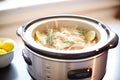 a crockpot with fermenting sauerkraut inside