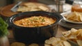 A crockpot filled with y buffalo chicken dip surrounded by chips and crackers for dipping Royalty Free Stock Photo