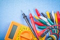 Crocodile cables composition digital multimeter on blue backgrou Royalty Free Stock Photo