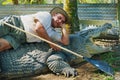 Crocodile farmer Tabone lays on the biggest monster reptile kept behind fence in Australia in Jonston River, Australia.