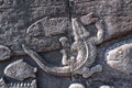 A crocodile hunting a fish sculpted in stone exterior wall of Bayon Temple, a historic UNESCO ancient heritage site