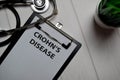 Crohn`s Disease write on a paperwork isolated on wooden table. medical concept