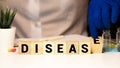 CROHNS DISEASE. TEXT ON A WOODEN BAR NEAR WOODEN CUBES. on a blue background