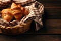 Croissant in a basket with cloth on a wooden table Royalty Free Stock Photo