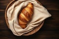 Croissant in a basket with cloth on a wooden table Royalty Free Stock Photo