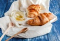 Croissant with a beautiful crisp and a jar of honey