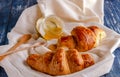 Croissant with a beautiful crisp and a jar of honey