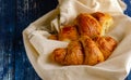 Croissant with a beautiful crisp on a light fabric