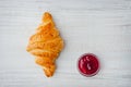 Croissant and berry jam on the table top view