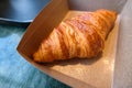 Croissant in the box on coffee break time Royalty Free Stock Photo