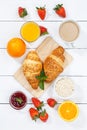 Croissant breakfast croissants orange juice coffee food wooden board from above portrait format Royalty Free Stock Photo