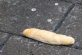 Croissant, bun thrown on a concrete pavement