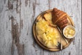 Croissant with butter and cheeses on the white vintage wooden old table. Free place for text