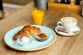 Croissant with butter, home made jam, fresh orange juice and coffee Royalty Free Stock Photo