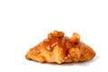 Croissant with caramel sauce and macadamia nut on white background