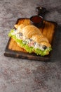 Croissant chicken salad sandwich closeup on a wooden board. Vertical Royalty Free Stock Photo