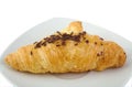 Croissant with chocolate on bright background.