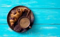 Croissant with chocolate on brown plate and cup of coffee Royalty Free Stock Photo