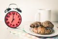 Croissant and coffee for Breakfast red alarm clock Royalty Free Stock Photo