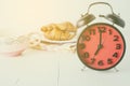 Croissant and coffee for Breakfast with red alarm clock Royalty Free Stock Photo