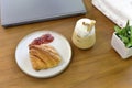 Croissant with coffee, French croissants on a plate and a cup of cabuchino coffee on wooden table background, top view Royalty Free Stock Photo