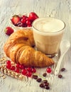 Croissant and coffee, fresh berries, healthy tasty breakfast Royalty Free Stock Photo