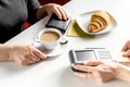 Croissant and coffee on white table payment by card in cafe Royalty Free Stock Photo